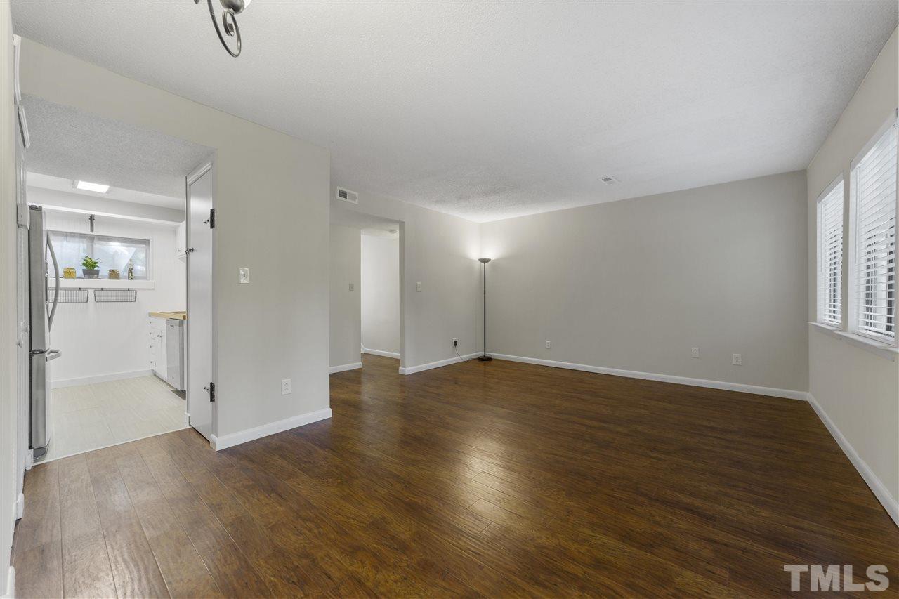 726 Godwin Court Raleigh, NC 27606 - Photo 11 of 23 an empty room with wooden floor and windows