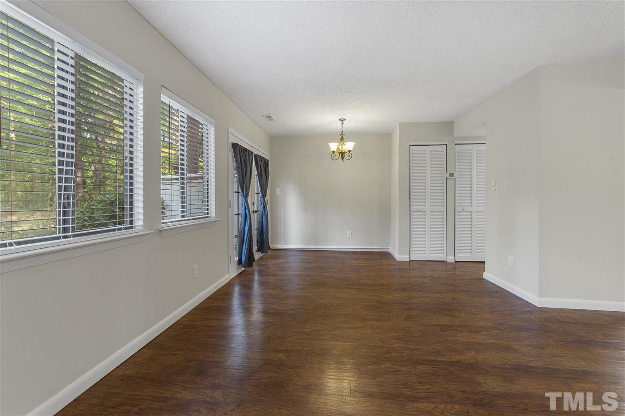 726 Godwin Court Raleigh, NC 27606 - Photo 12 of 23 a view of an empty room with wooden floor and a window
