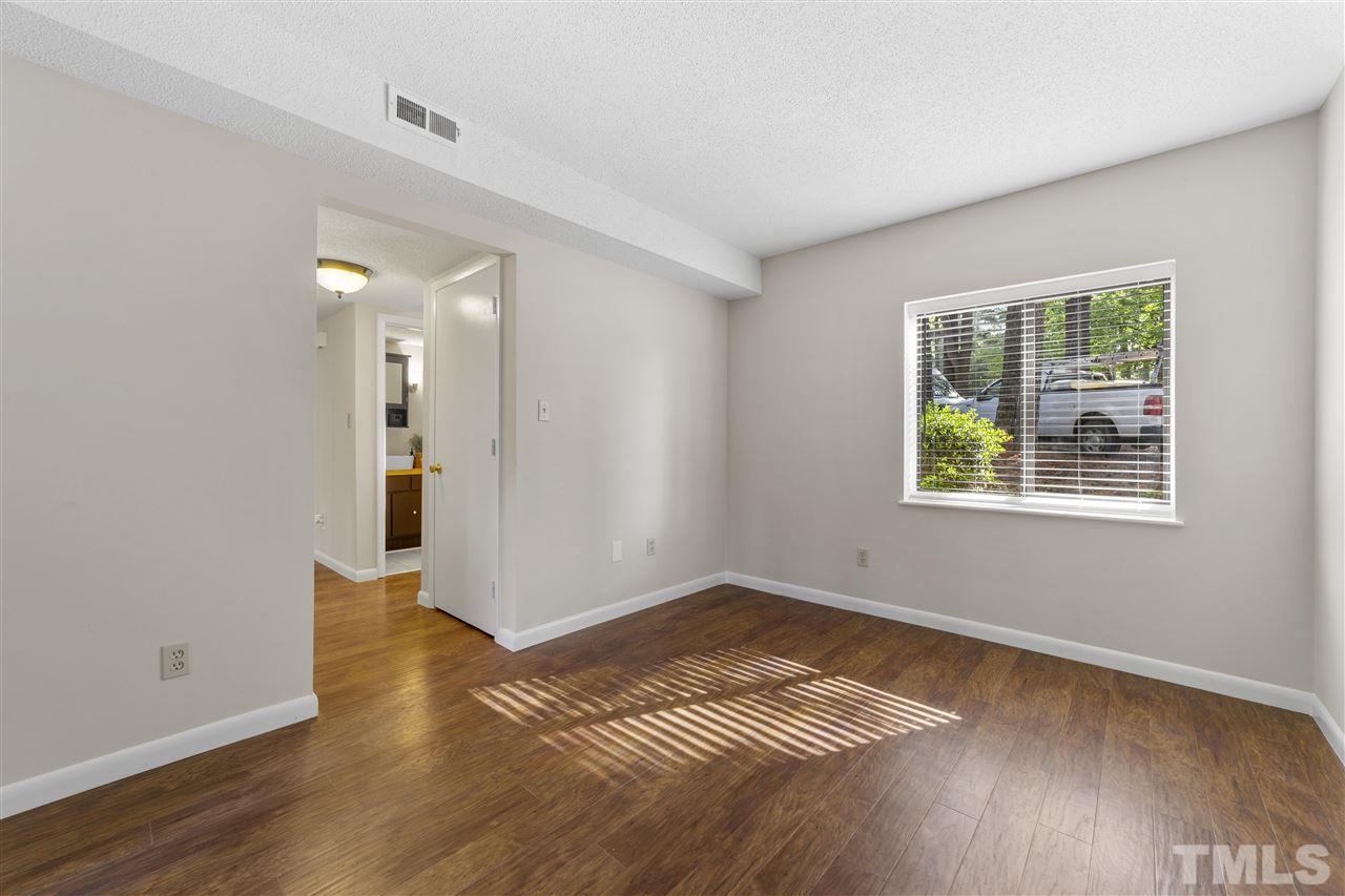 726 Godwin Court Raleigh, NC 27606 - Photo 13 of 23 an empty room with wooden floor and windows