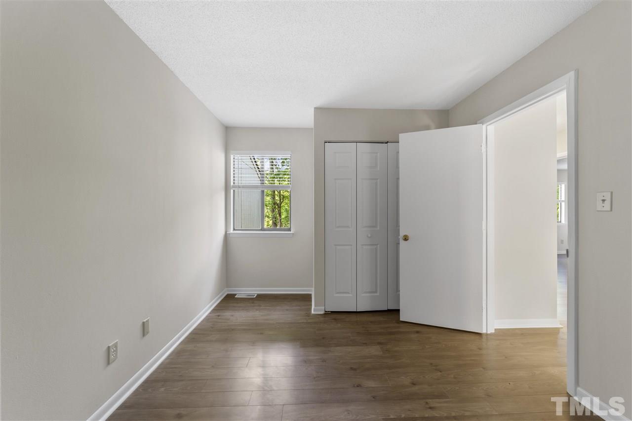 726 Godwin Court Raleigh, NC 27606 - Photo 16 of 23 an empty room with wooden floor and windows
