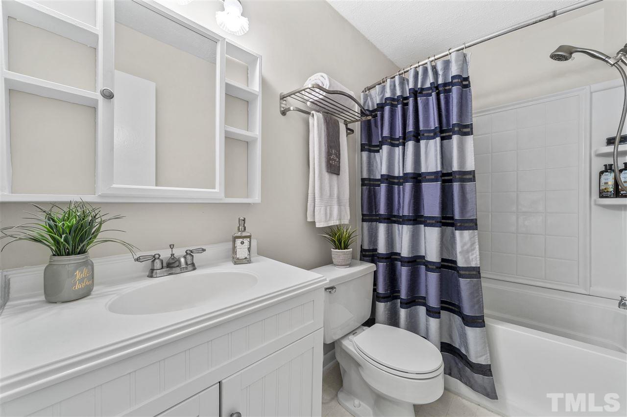 726 Godwin Court Raleigh, NC 27606 - Photo 18 of 23 a bathroom with a sink a toilet and shower