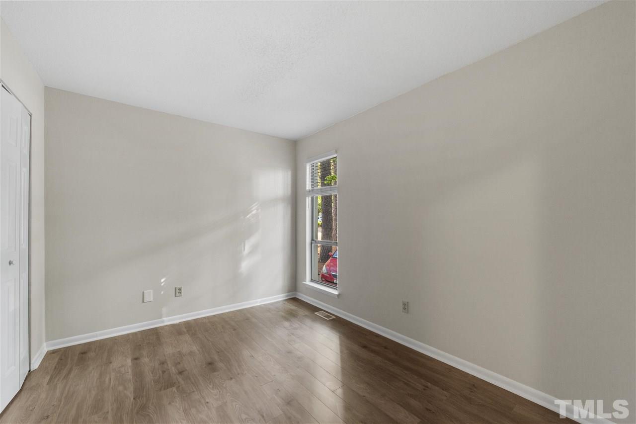 726 Godwin Court Raleigh, NC 27606 - Photo 19 of 23 an empty room with wooden floor and window