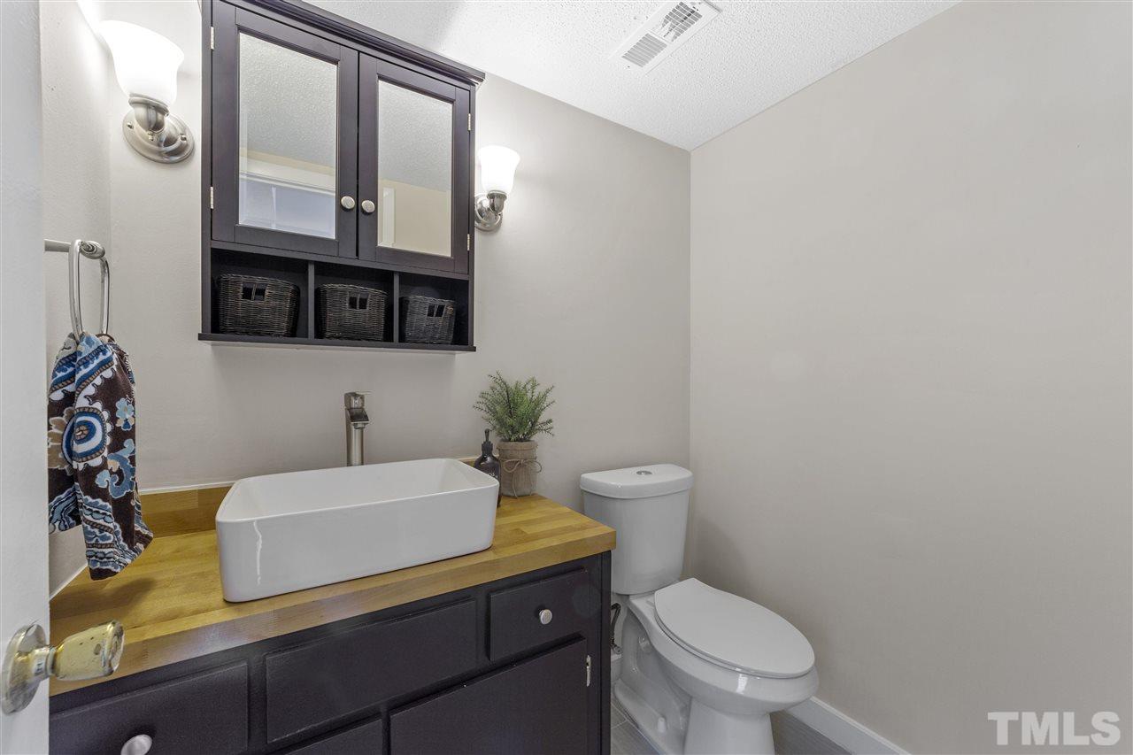726 Godwin Court Raleigh, NC 27606 - Photo 10 of 23 a bathroom with a granite countertop toilet sink and mirror