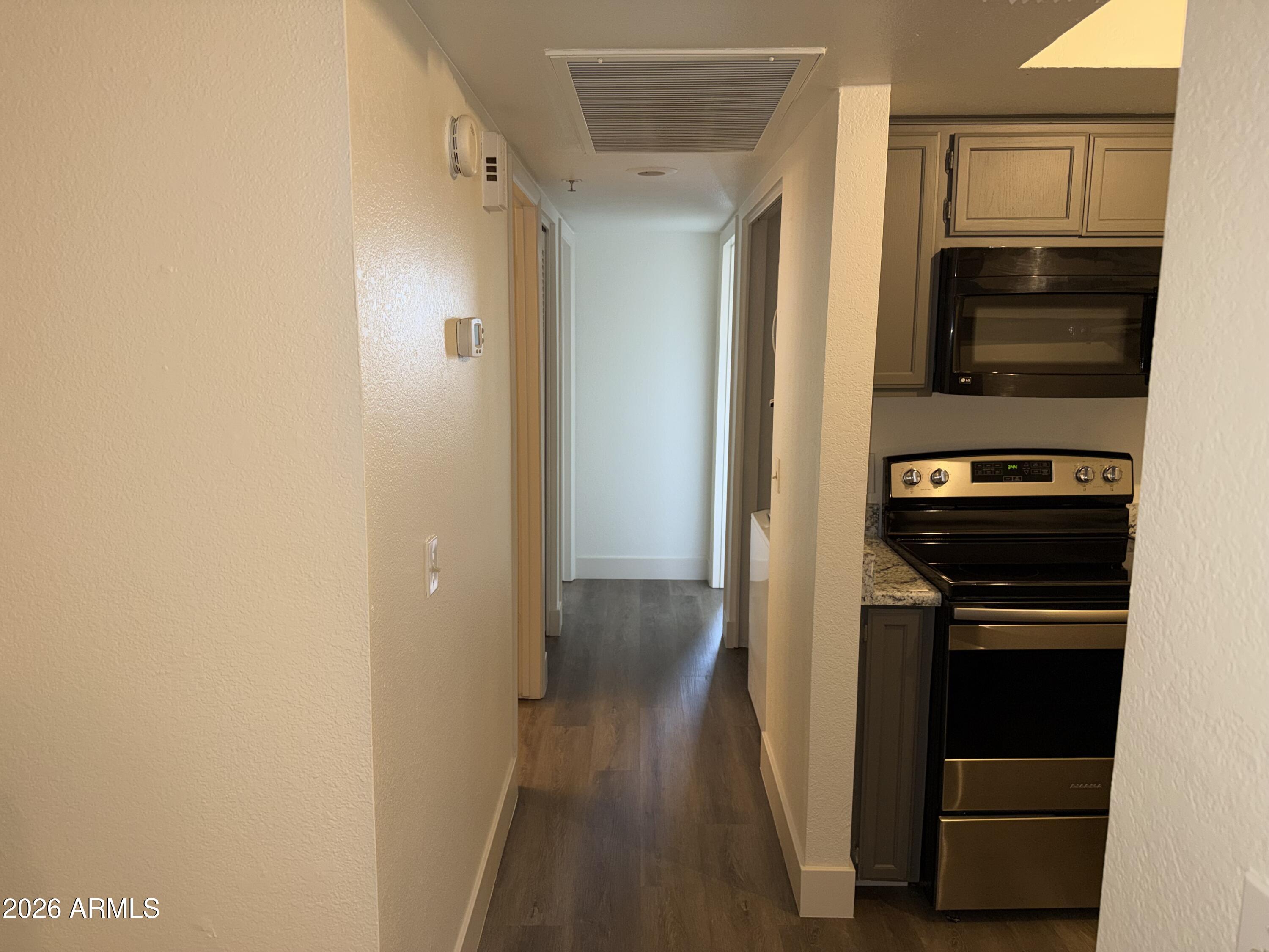 17 East Ruth Avenue, Unit 305 Phoenix, AZ 85020 - Photo 5 of 12 a view of a hallway with wooden floor and staircase