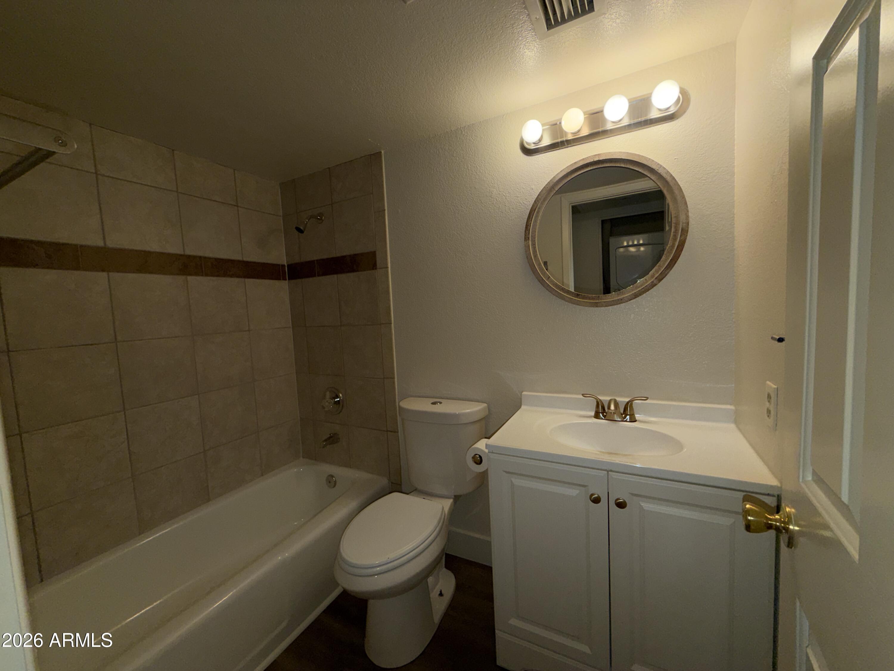 17 East Ruth Avenue, Unit 305 Phoenix, AZ 85020 - Photo 6 of 12 a bathroom with a sink a toilet and shower