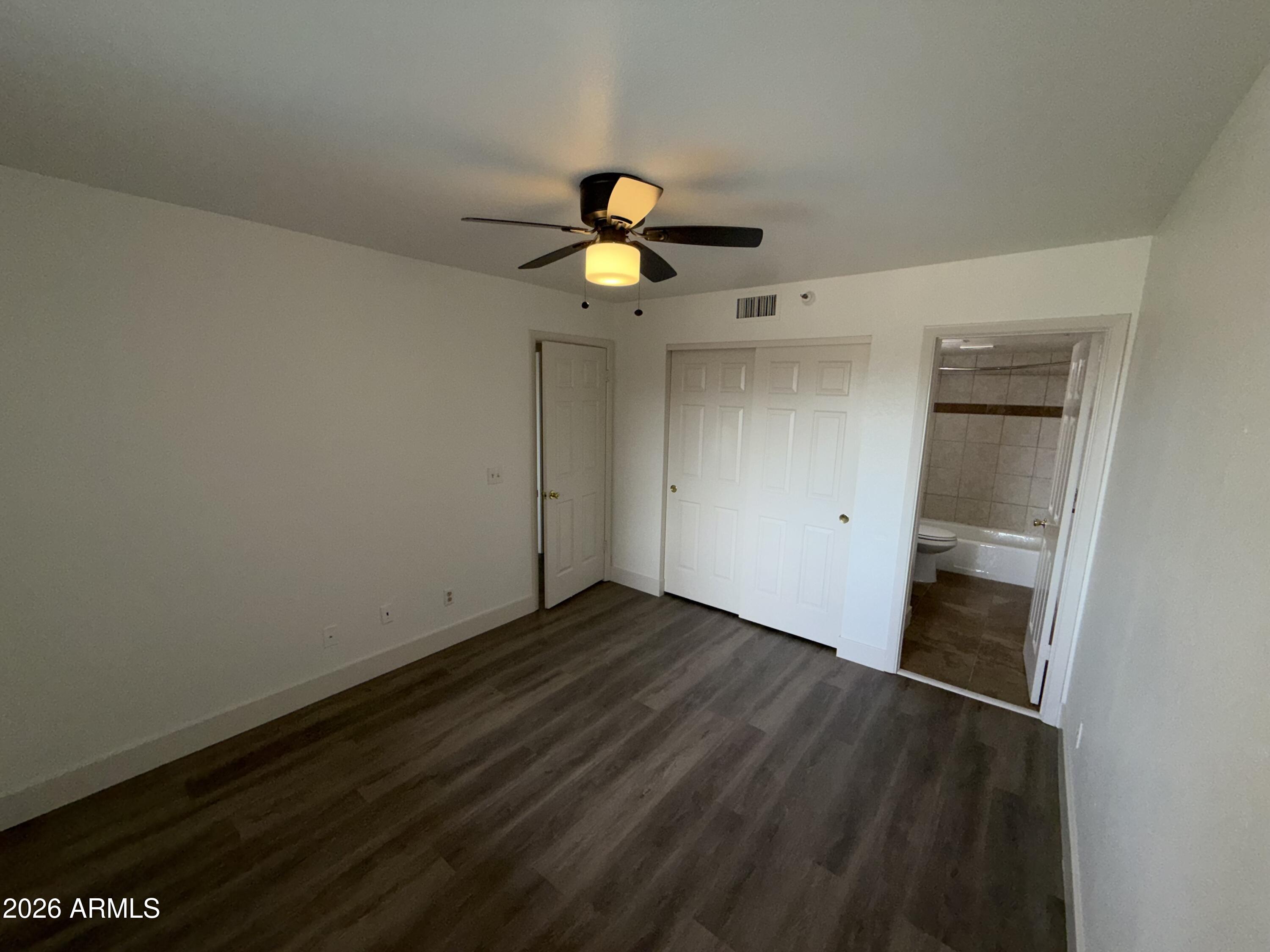 17 East Ruth Avenue, Unit 305 Phoenix, AZ 85020 - Photo 7 of 12 a view of empty room with wooden floor