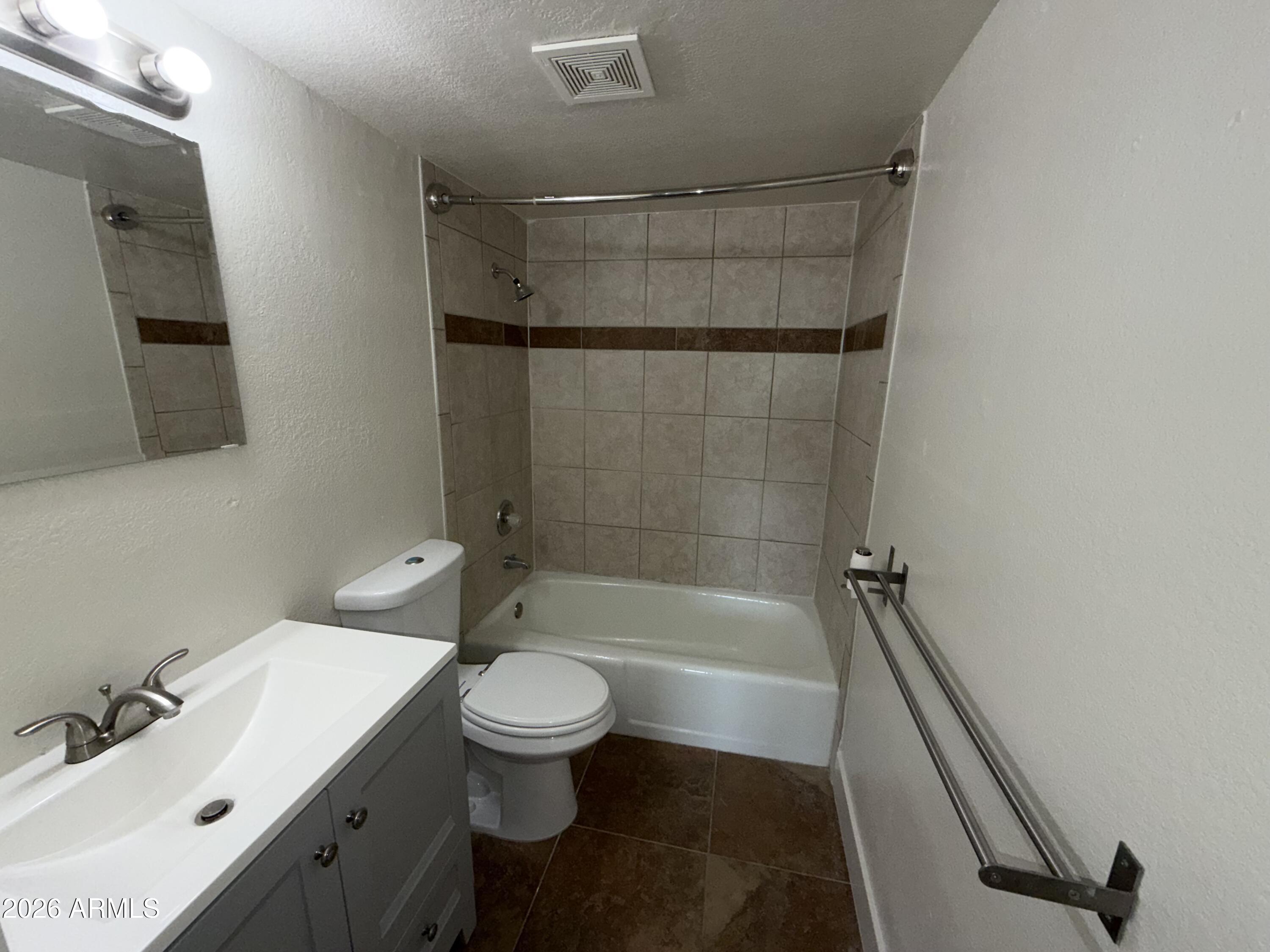 17 East Ruth Avenue, Unit 305 Phoenix, AZ 85020 - Photo 8 of 12 a bathroom with a sink a toilet and shower