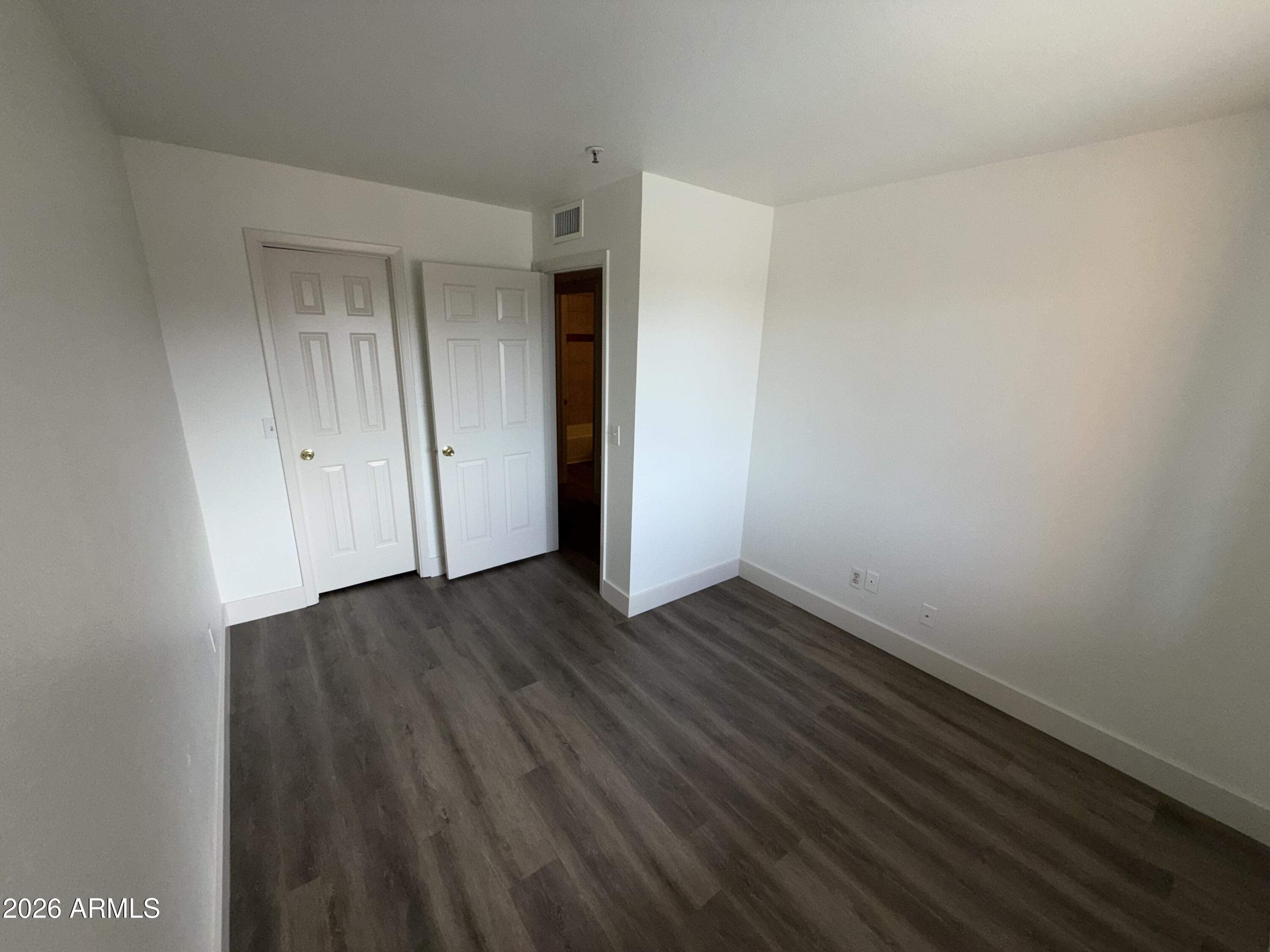 17 East Ruth Avenue, Unit 305 Phoenix, AZ 85020 - Photo 9 of 12 a view of an empty room with wooden floor