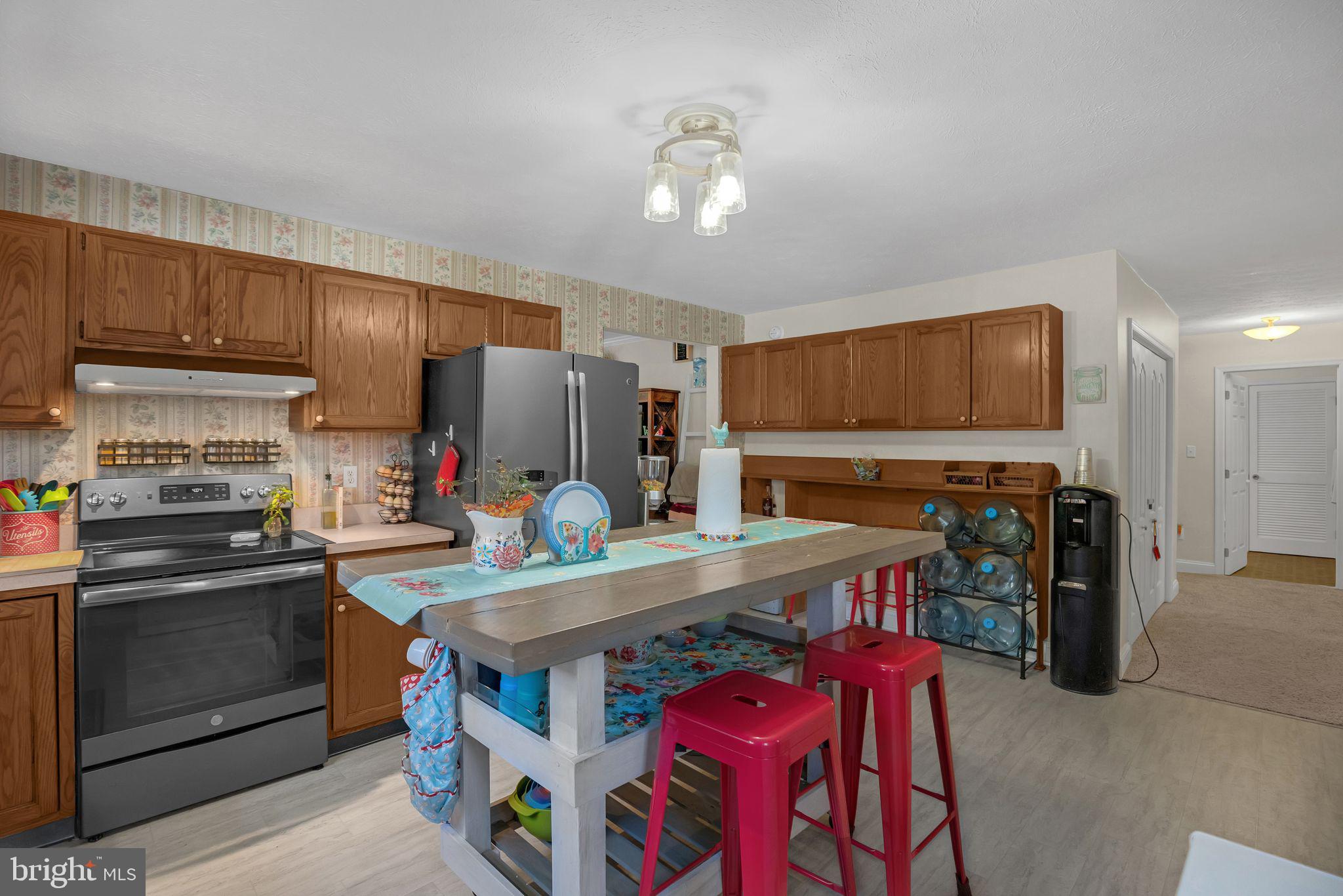 48550 Havirland Road Lexington Park, MD 20653 - Photo 11 of 36 a kitchen with stainless steel appliances granite countertop a stove refrigerator and a microwave