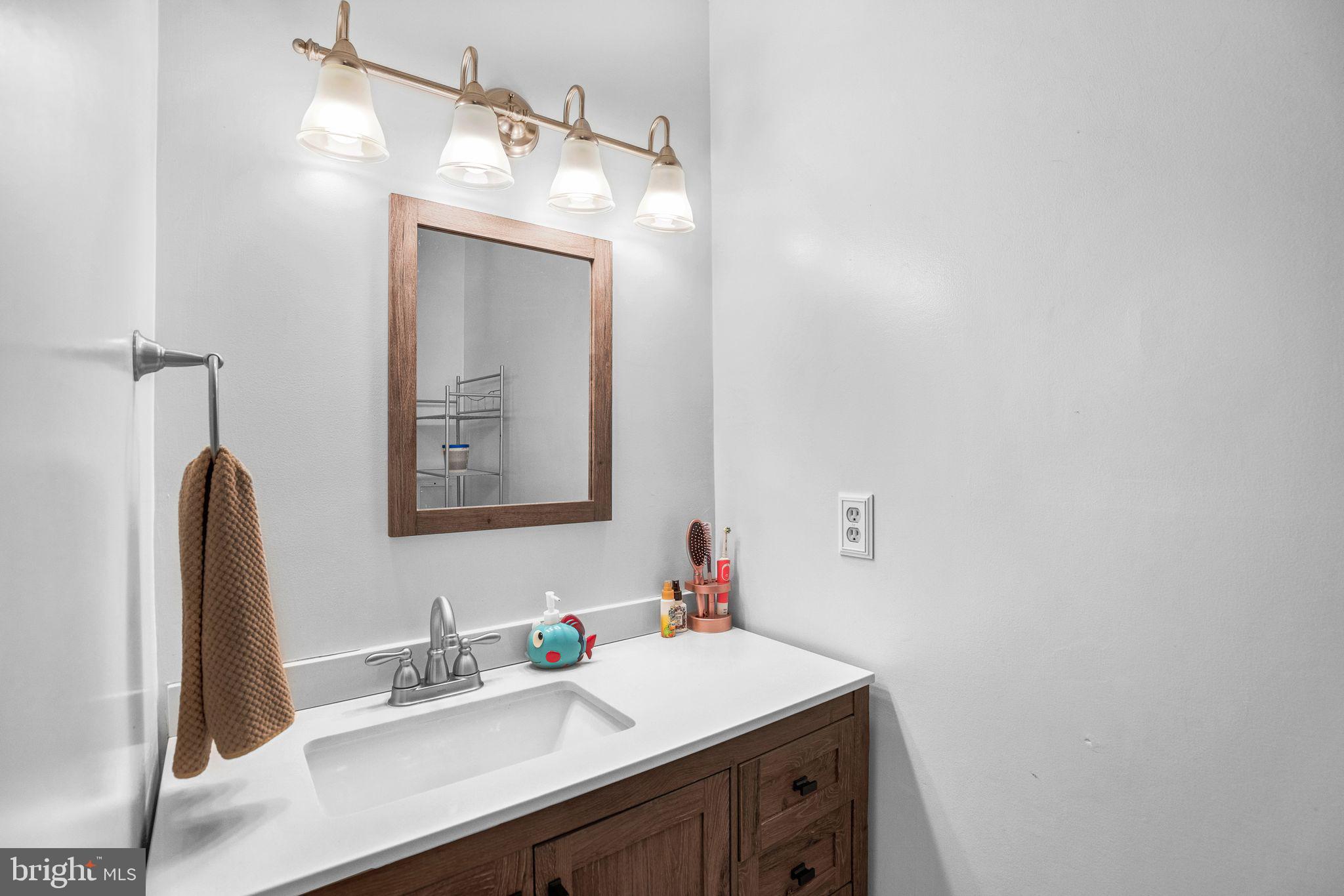 48550 Havirland Road Lexington Park, MD 20653 - Photo 17 of 36 a bathroom with a sink vanity and a mirror
