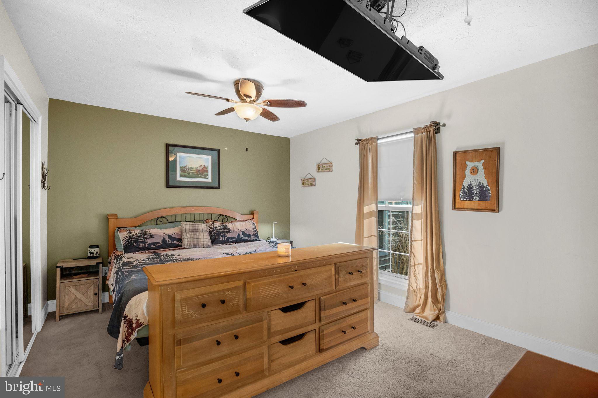 48550 Havirland Road Lexington Park, MD 20653 - Photo 19 of 36 a bedroom with a bed and a chandelier