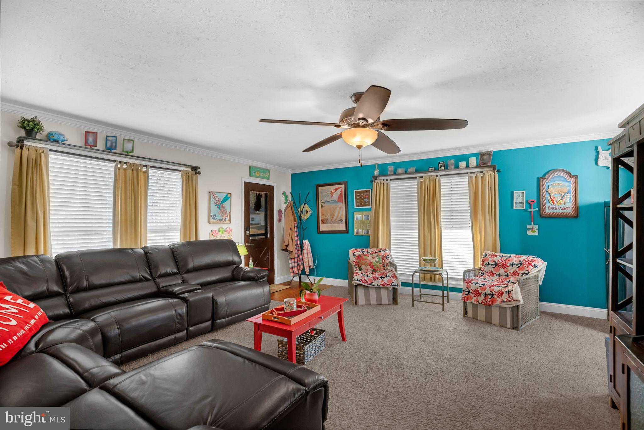 48550 Havirland Road Lexington Park, MD 20653 - Photo 8 of 36 a living room with furniture a fireplace and a large window