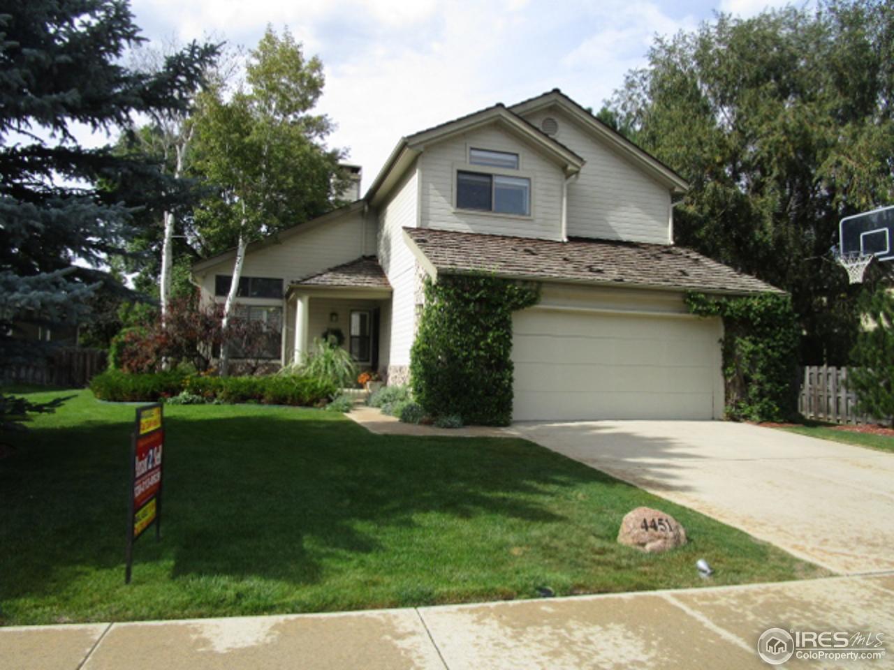 4451 Wellington Road Boulder, CO 80301 - Photo 1 of 25 a front view of a house with a garden and yard