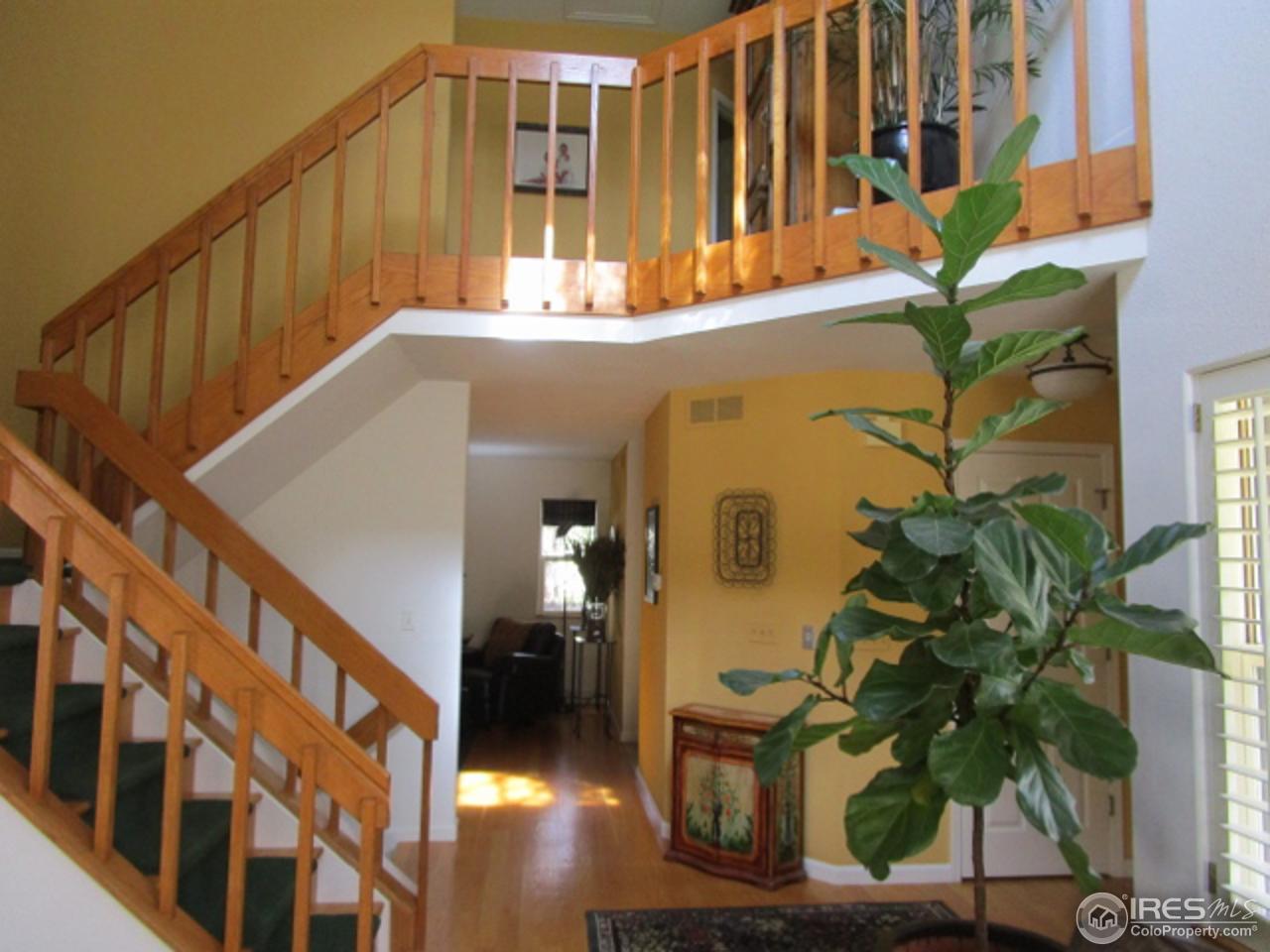 4451 Wellington Road Boulder, CO 80301 - Photo 12 of 25 a view of staircase with wooden floor and a potted plant