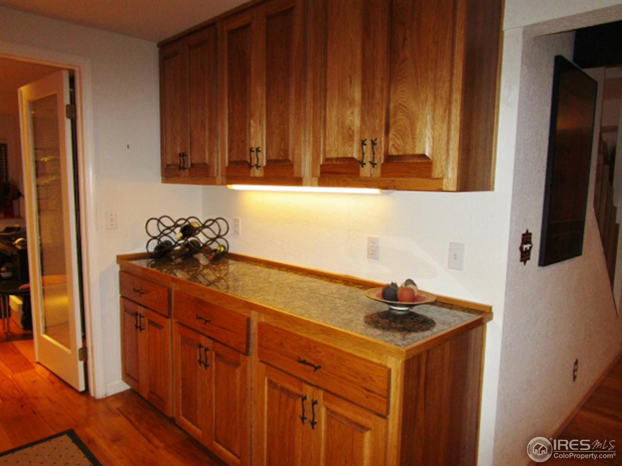 4451 Wellington Road Boulder, CO 80301 - Photo 23 of 25 a kitchen with stainless steel appliances a stove a refrigerator and cabinets