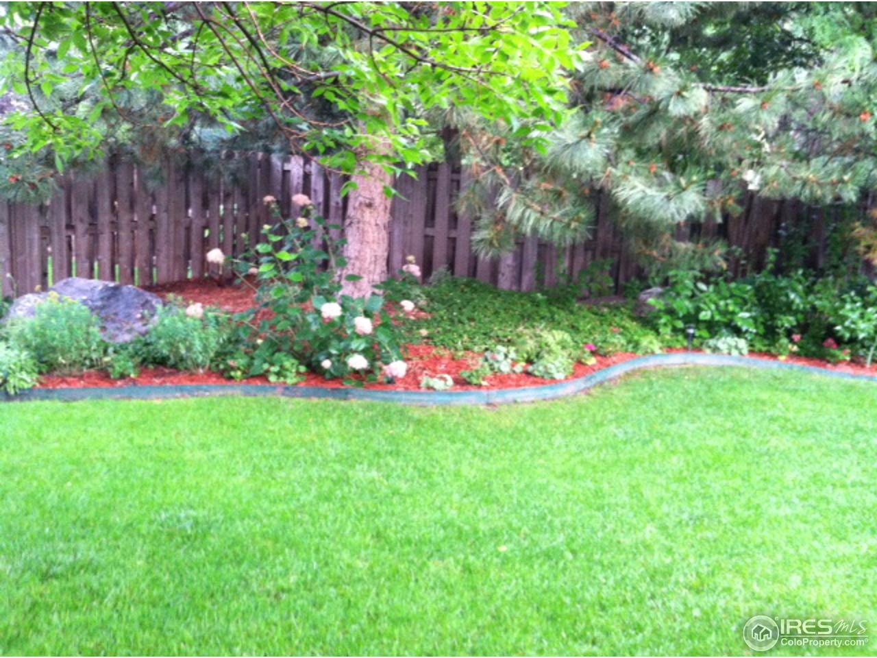 4451 Wellington Road Boulder, CO 80301 - Photo 24 of 25 a garden with flowers and wooden fence