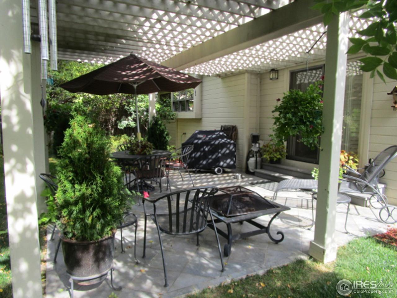 4451 Wellington Road Boulder, CO 80301 - Photo 25 of 25 a view of a patio with table and chairs potted plants