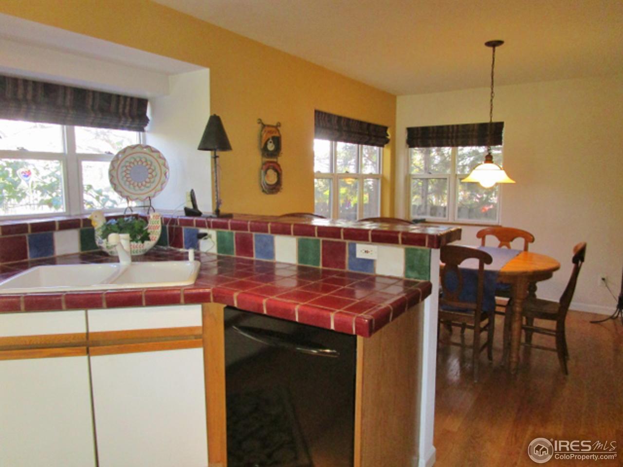 4451 Wellington Road Boulder, CO 80301 - Photo 5 of 25 a dining hall with a dining table chairs and large windows