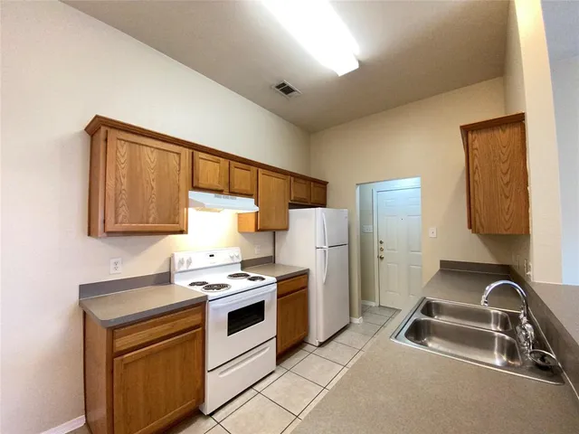 a kitchen with a sink cabinets and stainless steel appliances