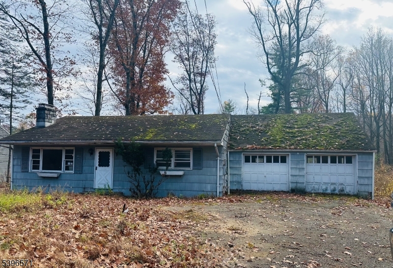 front view of a house with a tree