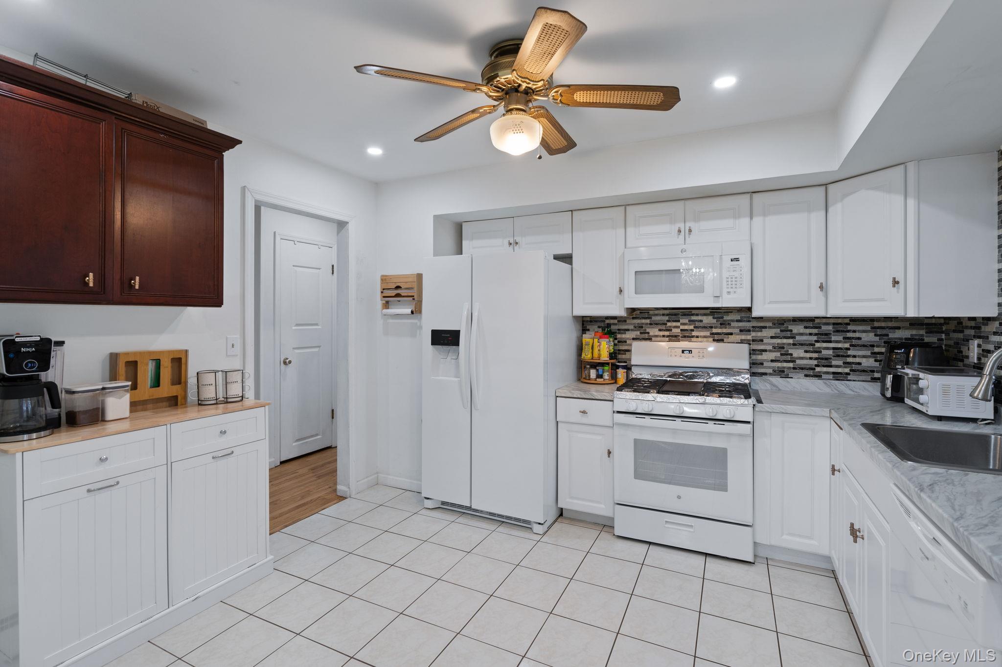 41 Rutledge Avenue Highland Mills, NY 10930 - Photo 8 of 25 Fully renovated with new appliances, cabinets, counters and tile flooring, leads to enclosed deck.