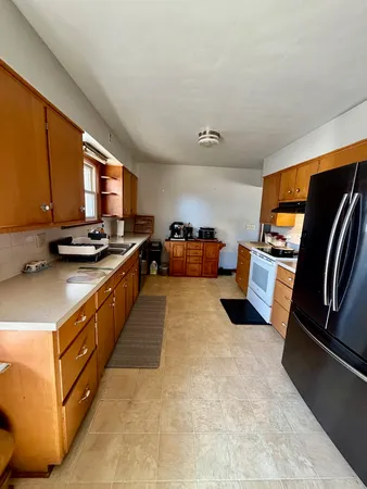 a kitchen with stainless steel appliances a stove a sink and a refrigerator