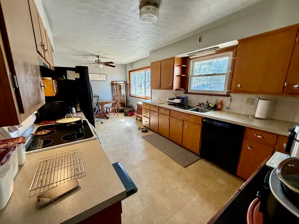 a kitchen with sink a refrigerator and cabinets