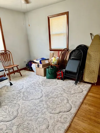 a bedroom with furniture and a wooden floor