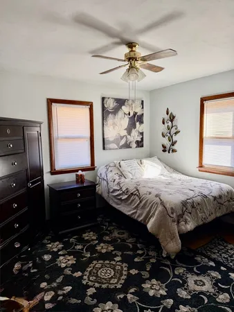 a bedroom with a bed and a chandelier