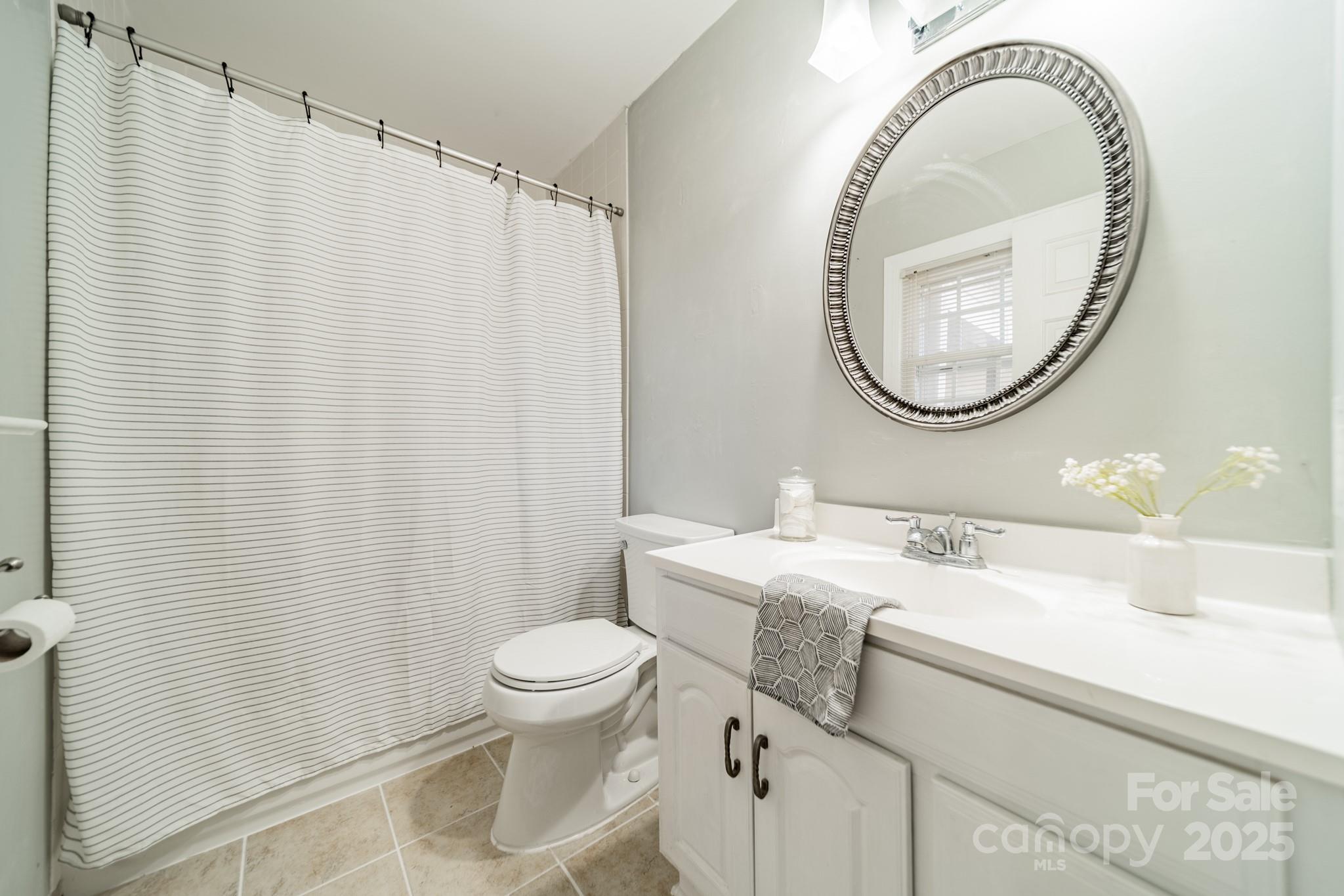 1300 Rama Road Charlotte, NC 28211 - Photo 19 of 30 a bathroom with a sink a toilet and a mirror