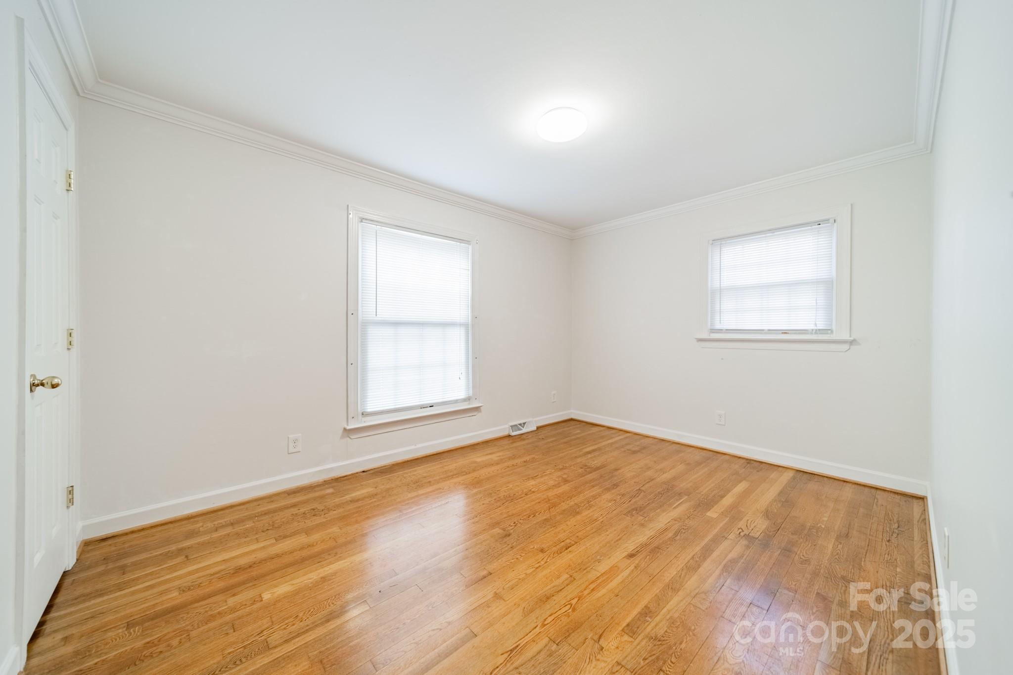 1300 Rama Road Charlotte, NC 28211 - Photo 20 of 30 an empty room with wooden floor and windows