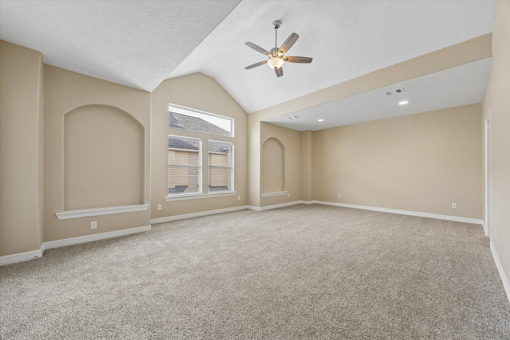 1417 Thompson Street Houston, TX 77007 - Photo 10 of 22 Spacious and serene, the primary bedroom offers a light-filled retreat with new flooring, fresh finishes, high vaulted ceilings, and 2 walk in closets offer a spacious retreat at the end of the day