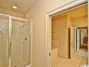 435 South Tryon Street, Unit 704 Charlotte, NC 28202 - Photo 12 of 13 a bathroom with a shower and a glass door
