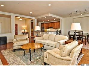 435 South Tryon Street, Unit 704 Charlotte, NC 28202 - Photo 3 of 13 a living room with furniture and a dining table
