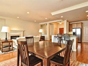 435 South Tryon Street, Unit 704 Charlotte, NC 28202 - Photo 4 of 13 a view of a dining room with furniture window and wooden floor