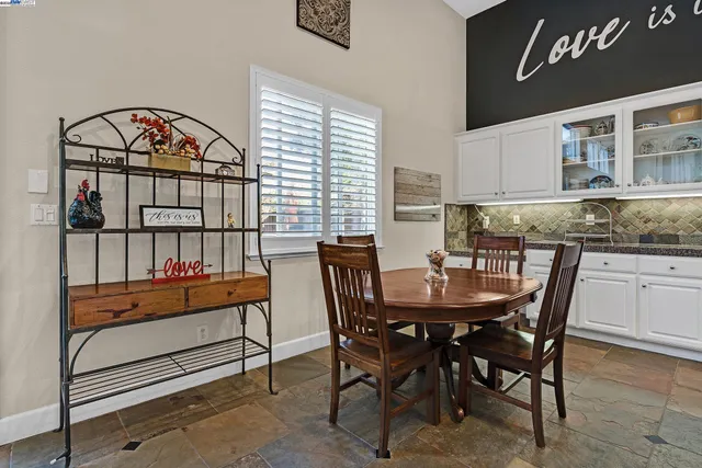 a dining room with furniture and wooden floor