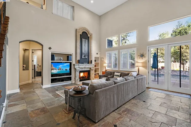 a living room with furniture a fireplace and a flat screen tv