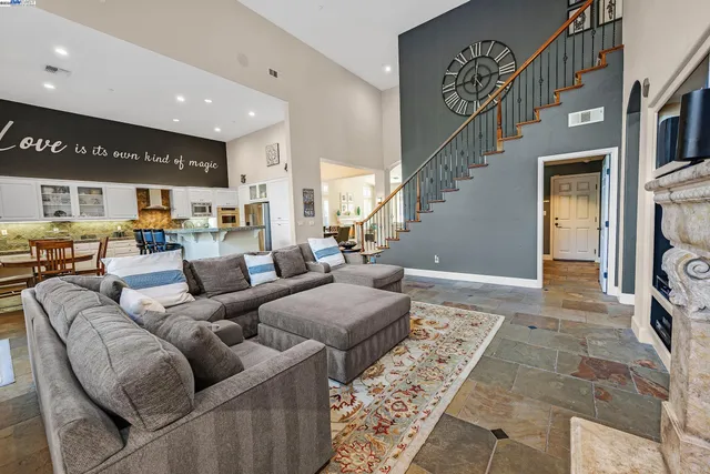 a living room with furniture fireplace and a rug