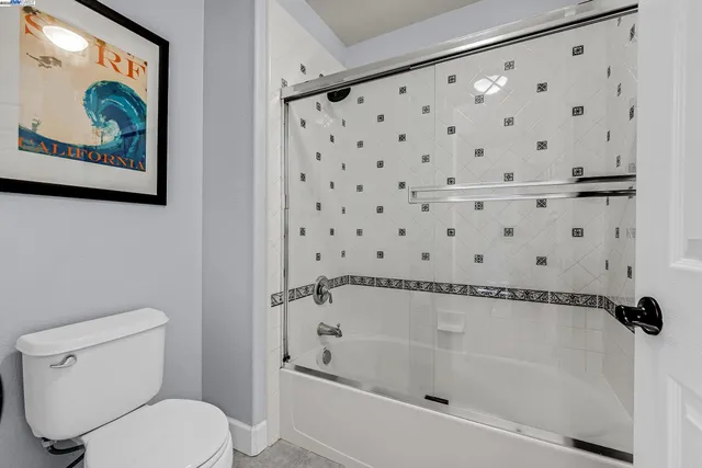 a bedroom with a bed desk and a window