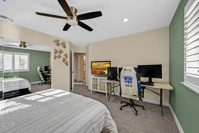 a bedroom with a bed gym equipment and a window