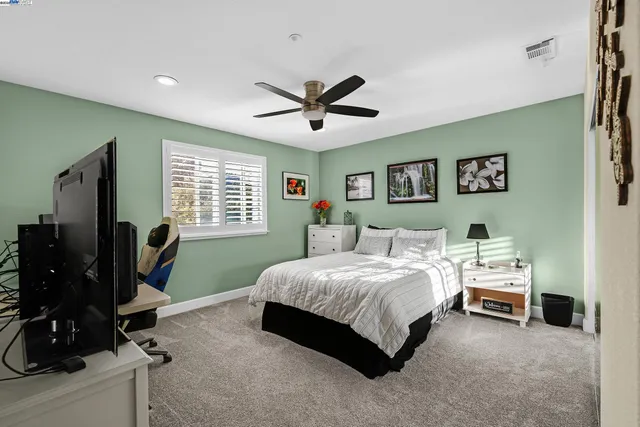 a bedroom with furniture and a chair