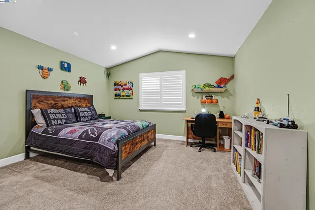 a bedroom with a bed and a window