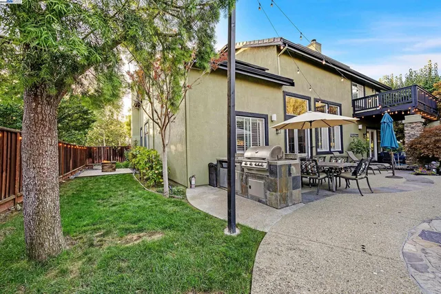 a view of a house with a yard and sitting area