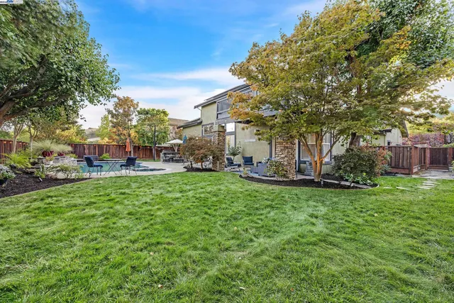 a view of a chairs and table in backyard