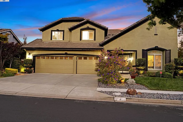 a view of a big house with a tree and a yard