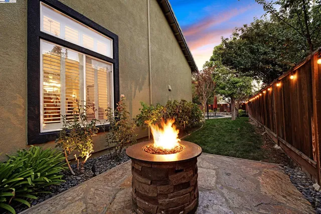 a view of a house with swimming pool and sitting area