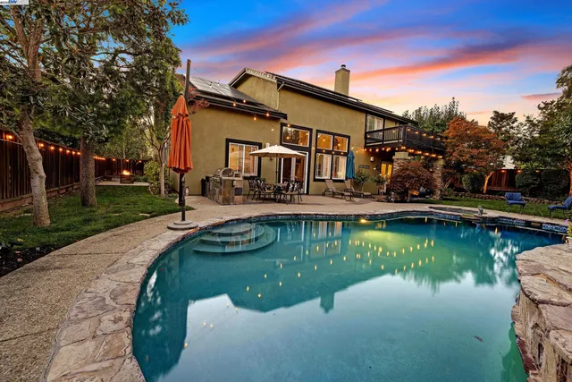 a view of a patio with couches table and chairs potted plants and palm tree