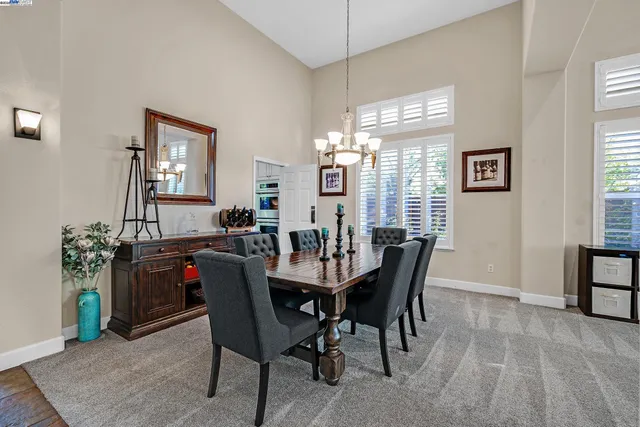 a view of a dining room with furniture and chandelier