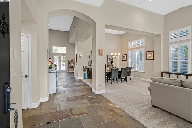 a living room with furniture and a dining table