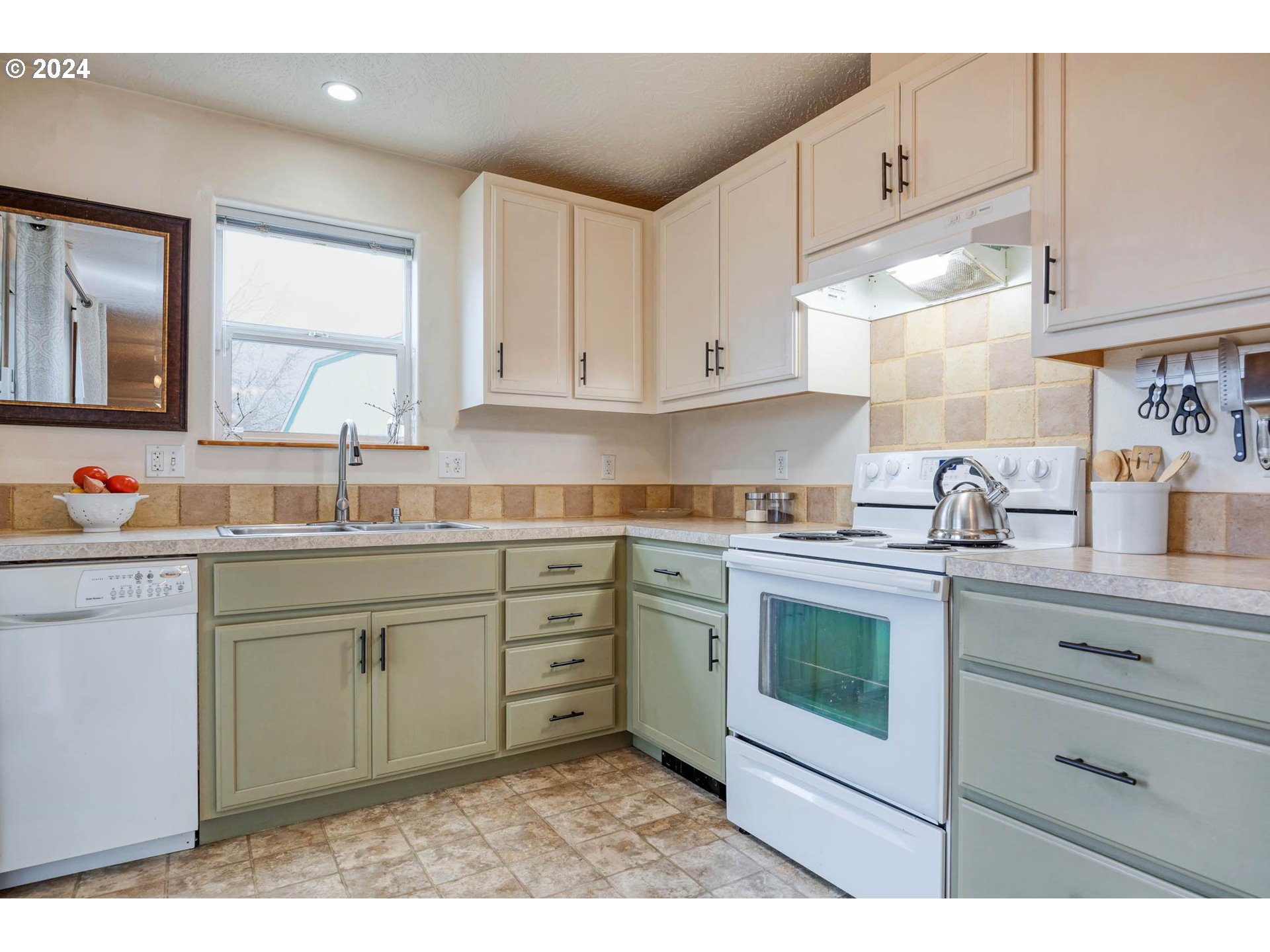4850 A Street Springfield, OR 97478 - Photo 17 of 40 a kitchen with granite countertop white cabinets sink and stainless steel appliances